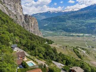 Experience breathtaking panoramic views from this stunning property nestled against a dramatic cliff face.