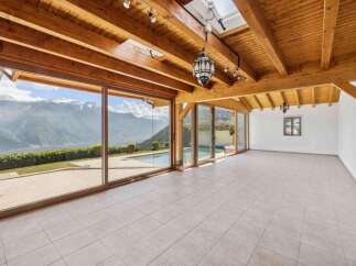 Experience breathtaking mountain views from this stunning property, featuring expansive glass walls that seamlessly blend indoor and outdoor living.