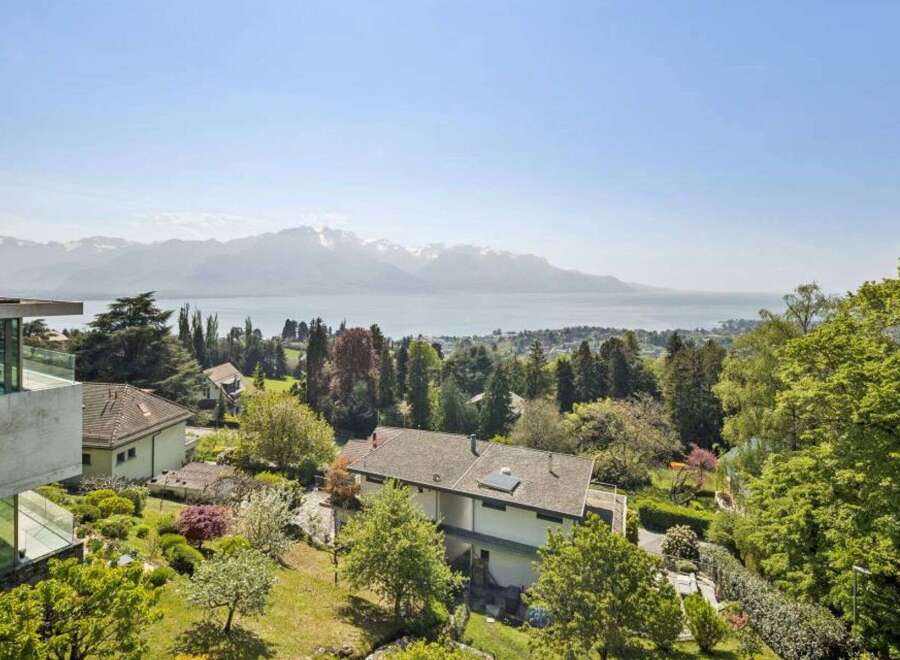 Experience breathtaking views from this stunning property, featuring a modern design and lush landscaping.