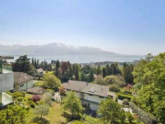 Experience breathtaking views from this stunning property, featuring a modern design and lush landscaping.
