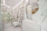 Step into luxury with this stunning bathroom featuring exquisite marble tile and modern fixtures.