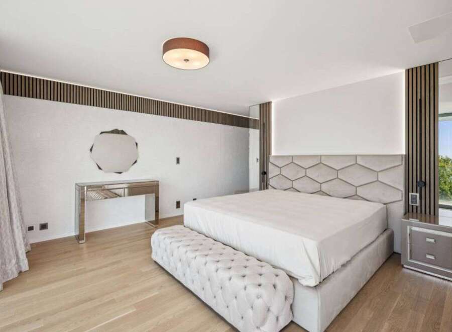 Step into luxury with this stunning bedroom, featuring a modern design and high-end finishes.