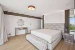 Step into luxury with this stunning bedroom, featuring a modern design and high-end finishes.