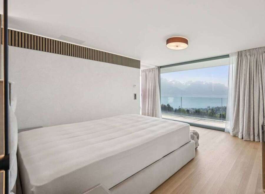 Experience luxury living in this stunning bedroom with breathtaking views.
