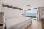 Experience luxury living in this stunning bedroom with breathtaking views.