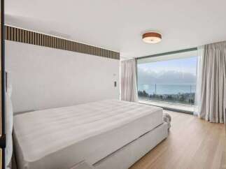 Experience luxury living in this stunning bedroom with breathtaking views.