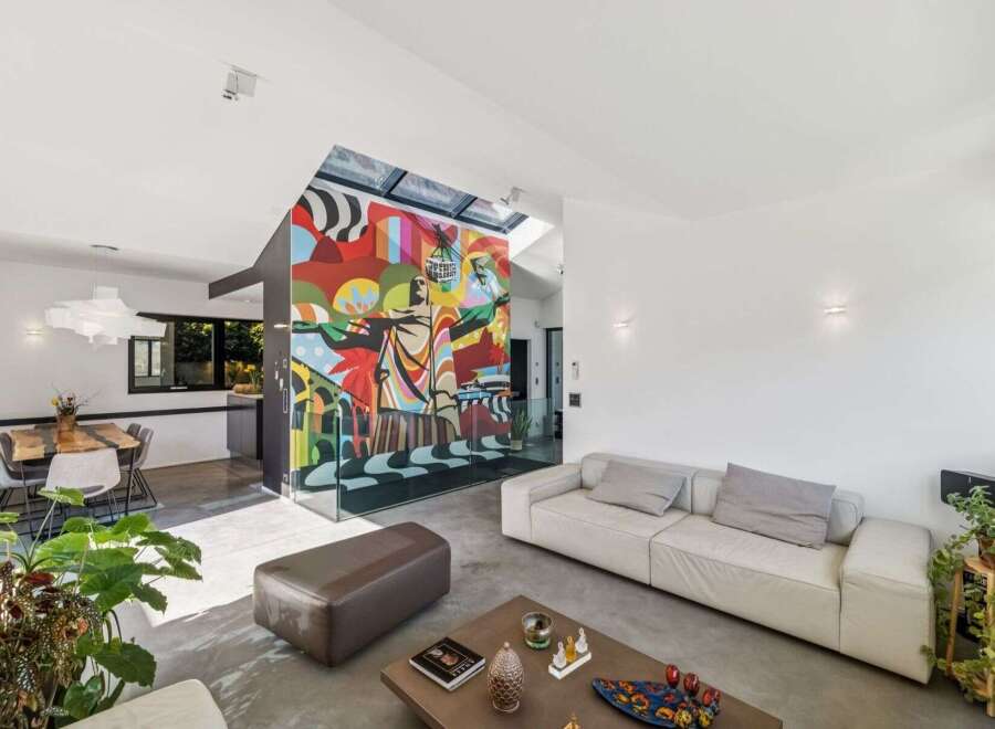 Experience modern luxury in this stunning property, featuring a vibrant mural that adds a unique artistic touch.