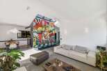 Experience modern luxury in this stunning property, featuring a vibrant mural that adds a unique artistic touch.