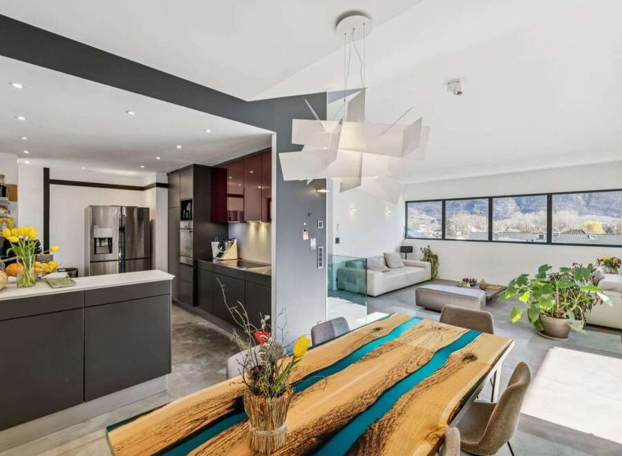 Experience modern luxury in this stunning property featuring a unique epoxy resin dining table, perfect for entertaining.