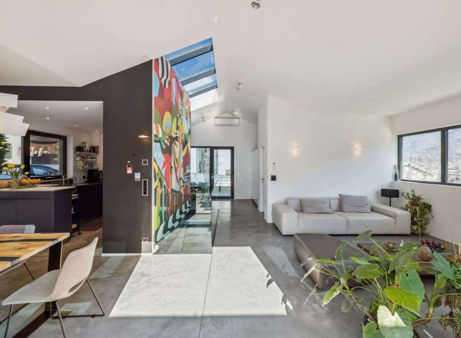 Experience modern living in this stunning property featuring a vibrant mural accent wall and sleek, contemporary design.