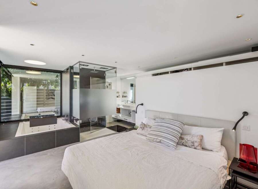 Experience luxury living in this stunning bedroom featuring a modern design and open layout.