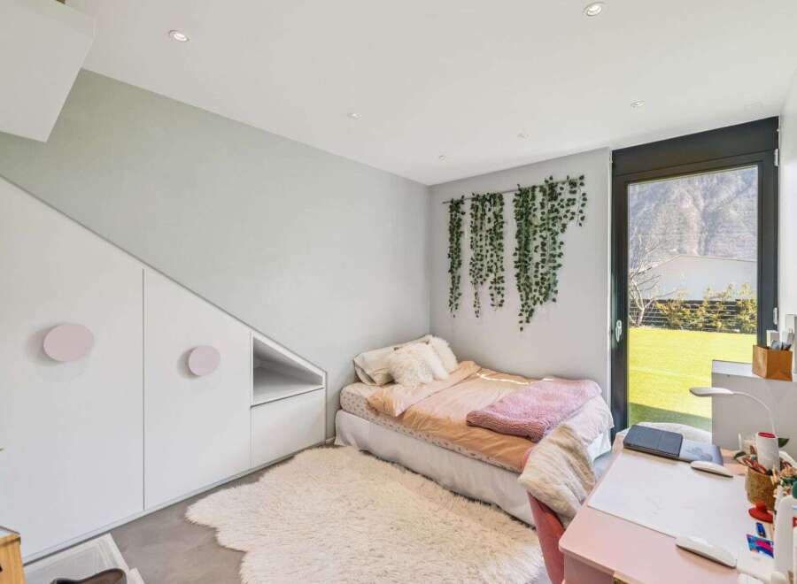 This charming bedroom features a cozy bed with a fluffy rug, creating a warm and inviting atmosphere.