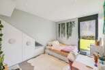 This charming bedroom features a cozy bed with a fluffy rug, creating a warm and inviting atmosphere.