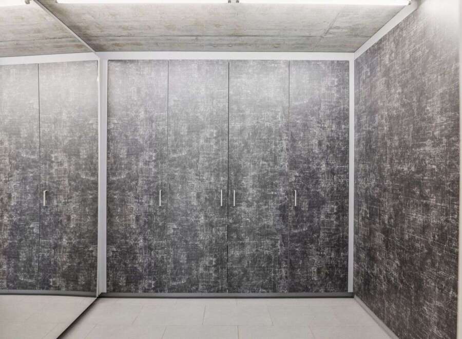 This modern space features a stunning built-in wardrobe with a unique textured design, offering ample storage and a sleek aesthetic.