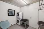 Discover the convenience of this well-equipped laundry room! Featuring a modern stacked washer and dryer, this space is designed for efficiency.