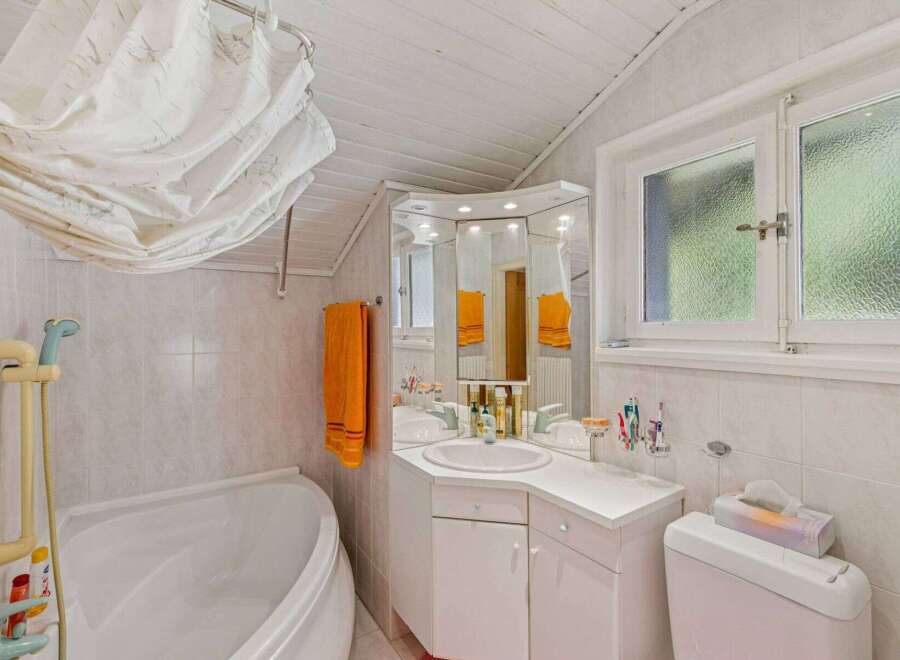 This charming bathroom features a bright and airy design, perfect for starting your day.