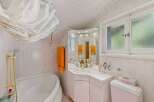 This charming bathroom features a bright and airy design, perfect for starting your day.