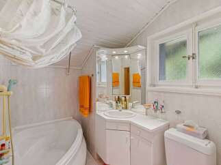 This charming bathroom features a bright and airy design, perfect for starting your day.