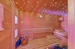 Step into your own private oasis with this stunning sauna! Featuring beautiful wooden paneling, a relaxing bench, and a starry ceiling, this space is designed for ultimate relaxation.