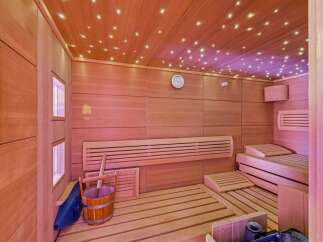 Step into your own private oasis with this stunning sauna! Featuring beautiful wooden paneling, a relaxing bench, and a starry ceiling, this space is designed for ultimate relaxation.