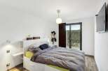 This modern bedroom offers a serene retreat with its minimalist design and ample natural light.