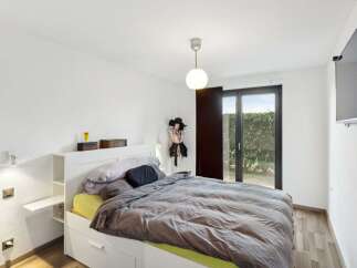 This modern bedroom offers a serene retreat with its minimalist design and ample natural light.