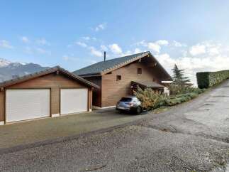 Discover this stunning property featuring a beautiful wooden house with a two-car garage.