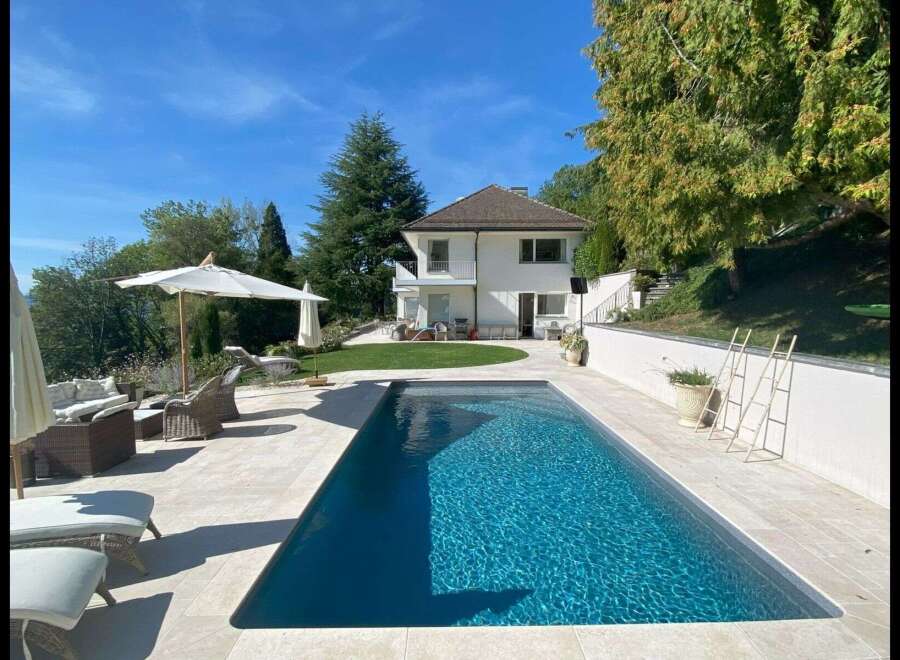 Discover luxury living in this stunning property featuring a private pool and lush landscaping.