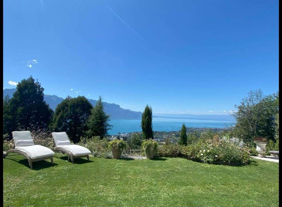 Enjoy breathtaking views from this stunning property! Featuring a lush green lawn, comfortable lounge chairs, and meticulously maintained landscaping, this home offers the perfect blend of luxury and tranquility.