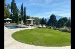Experience luxury living in this stunning property featuring a private pool, lush green lawn, and breathtaking mountain views.