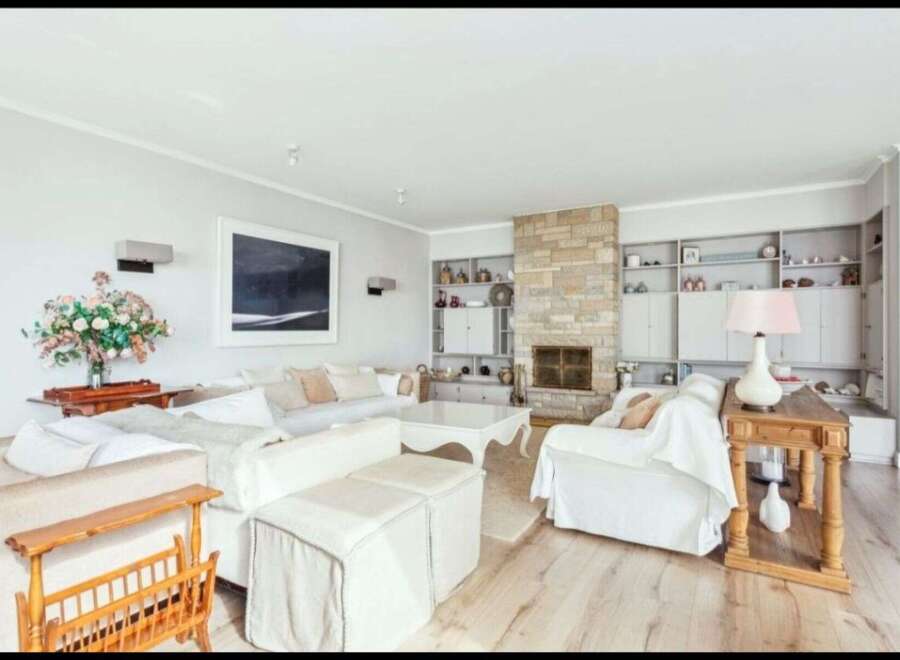 This stunning living room boasts a cozy fireplace, perfect for those chilly evenings.