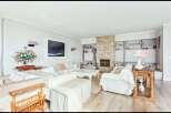 This stunning living room boasts a cozy fireplace, perfect for those chilly evenings.