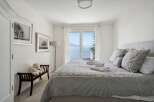 This charming bedroom offers a serene retreat with stunning views.