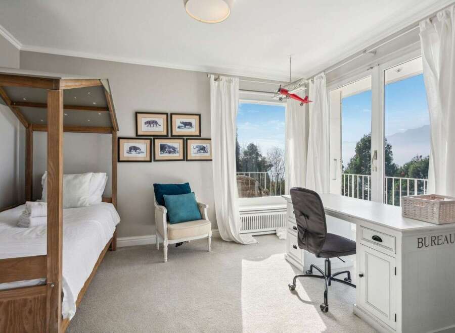 This stunning bedroom boasts a bright and airy atmosphere, perfect for relaxation and productivity.