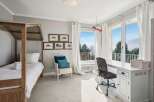 This stunning bedroom boasts a bright and airy atmosphere, perfect for relaxation and productivity.