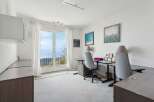 Enjoy breathtaking views from this stunning home office! This bright and airy space features a large window, perfect for letting in natural light and enjoying the scenery.