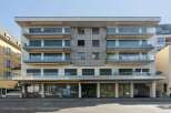 Discover modern living in this stunning building, featuring sleek glass balconies and a contemporary facade.