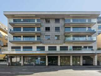 Discover modern living in this stunning building, featuring sleek glass balconies and a contemporary facade.