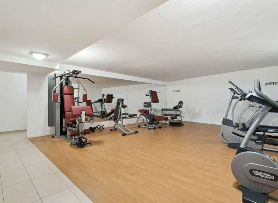 This well-equipped gym offers a variety of exercise machines, including a multi-station weight machine, elliptical trainers, and free weights.