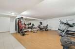 This well-equipped gym offers a variety of exercise machines, including a multi-station weight machine, elliptical trainers, and free weights.