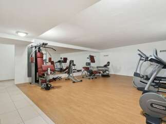 This well-equipped gym offers a variety of exercise machines, including a multi-station weight machine, elliptical trainers, and free weights.