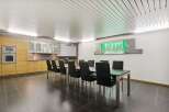 This modern space features a sleek dining area perfect for meetings or gatherings.