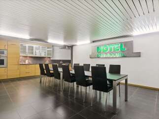 This modern space features a sleek dining area perfect for meetings or gatherings.