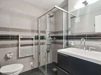 Step into a modern bathroom oasis! This stylish space features a sleek glass shower, a contemporary vanity, and elegant tile work.