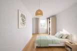 This inviting bedroom features a minimalist design with a touch of nature-inspired decor.