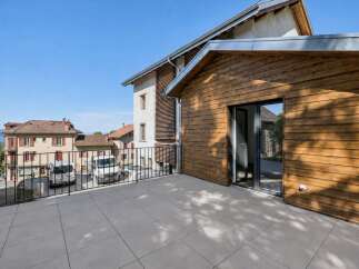 Enjoy the outdoors from this spacious balcony, featuring a modern tiled floor and a sleek metal railing.