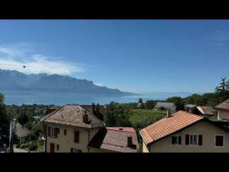 Experience breathtaking panoramic views of the serene lake and majestic mountains from this stunning property.