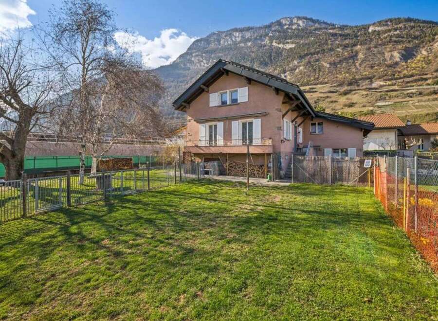 Nestled against a stunning mountain backdrop, this charming property offers a serene living experience.
