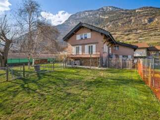 Nestled against a stunning mountain backdrop, this charming property offers a serene living experience.