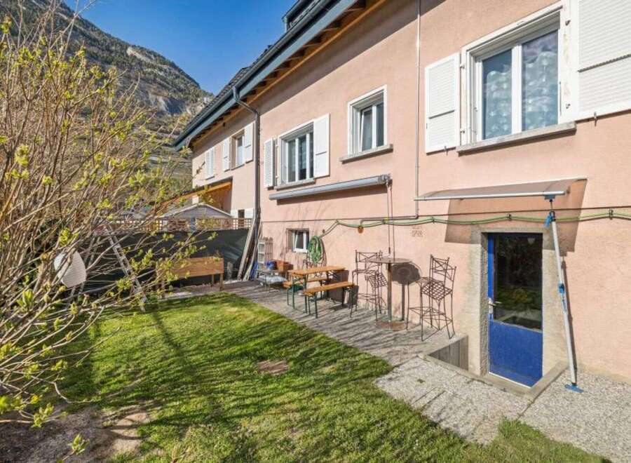 Discover this charming property featuring a well-maintained lawn and inviting outdoor seating, perfect for relaxation and entertaining.